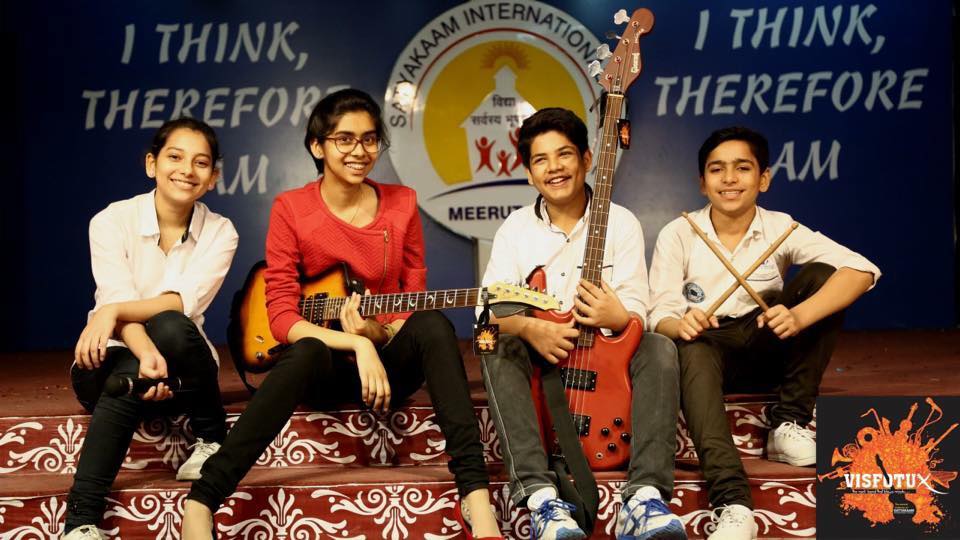 Students performing on stage at Satyakaam International School